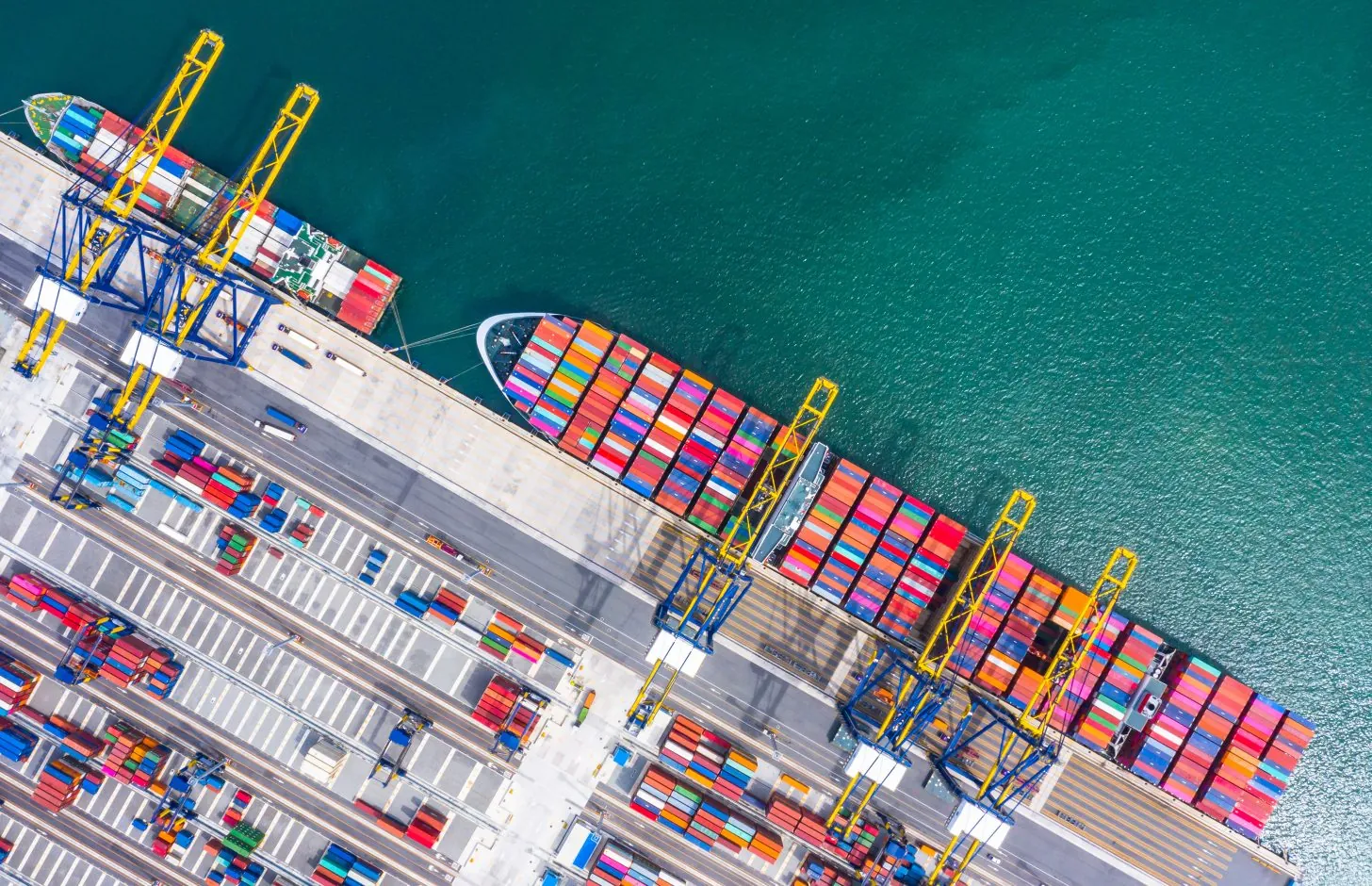 Container ship loading and unloading in deep sea port, Aerial top view of business logistic import and export freight transportation by container ship in open sea.