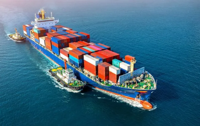 Aerial view of cargo ship with cargo container on sea.