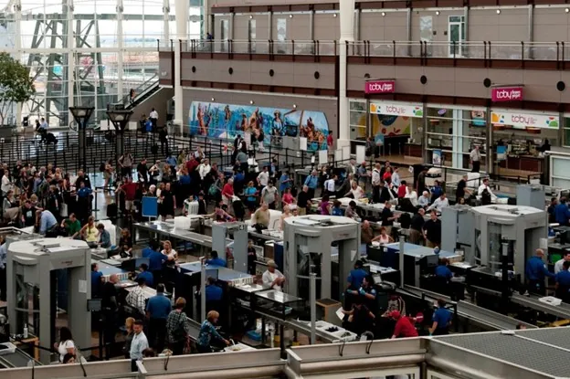 A shot of a busy airport with scanning machines