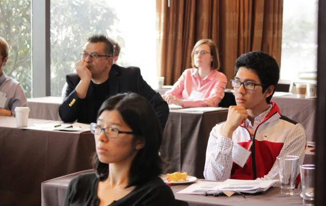 Attendees sitting at tables while attending a workshop